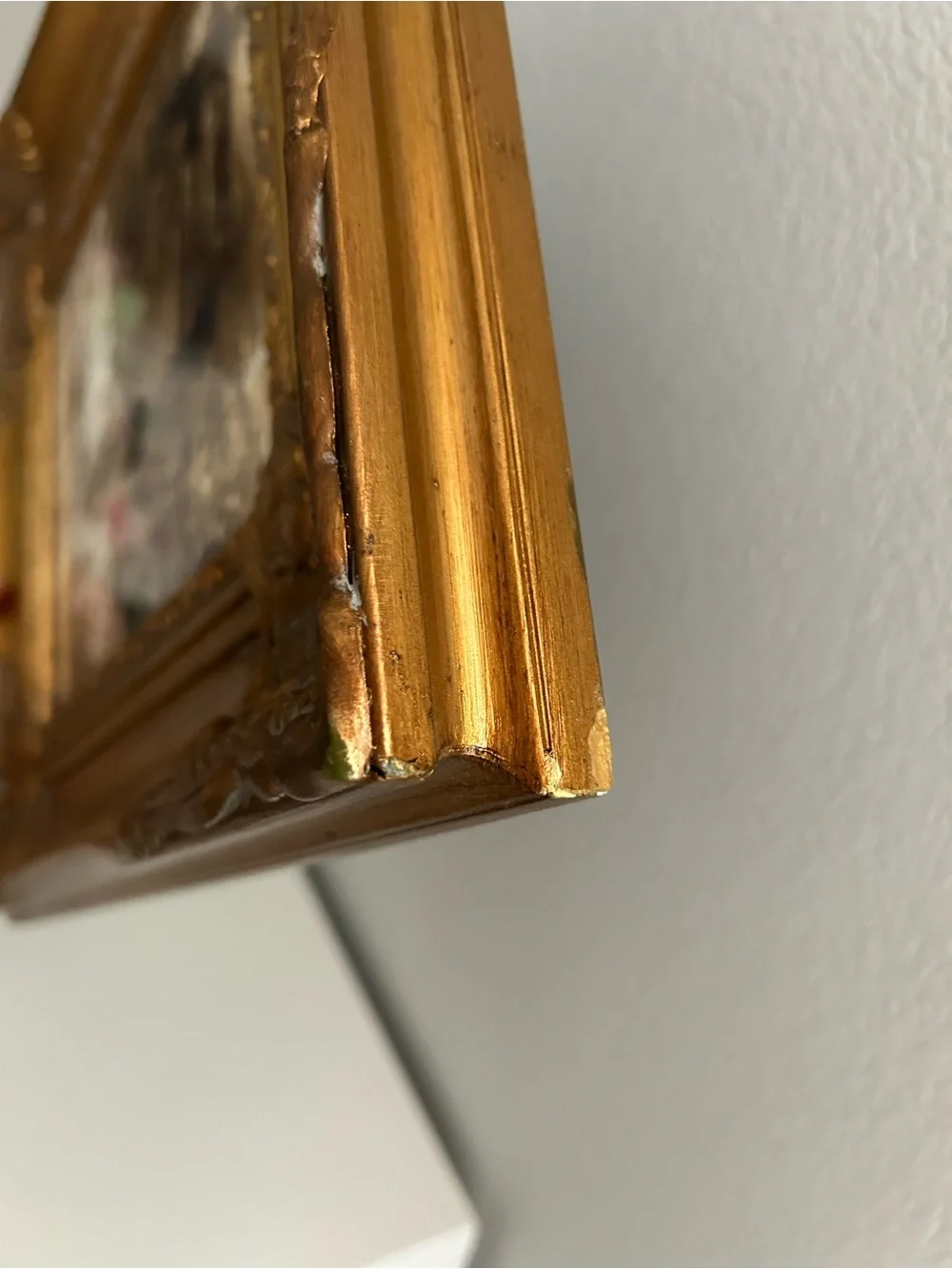 Framed art in gilded ornate frame